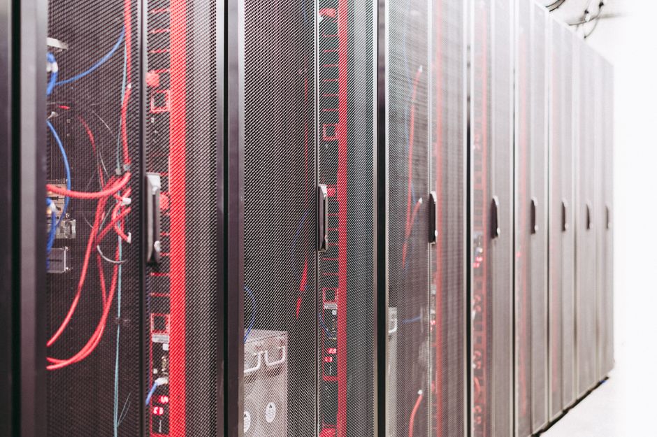 Server racks in a data center with status lights showing active monitoring.