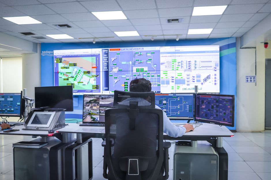 A network operations center with multiple screens showing real-time data.